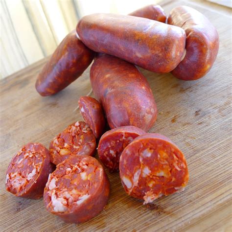 Chorizzo. How Spanish chorizo is made. Shutterstock. Spanish chorizo is usually a cured and hard sausage made from coarsely chopped pork. It is often made from cuts of pork such as the loin, jowl, belly, and sometimes the shoulder, though it always contains back fat for its rich fat content (via Masterclass ). Spanish chorizo gets its bright red color ... 