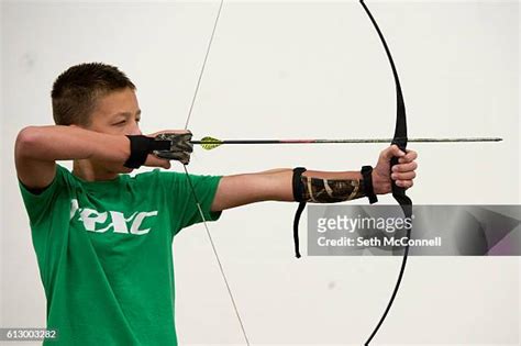 Chris Bruntsch pulls arrows from a target at Quick Draw Archery in