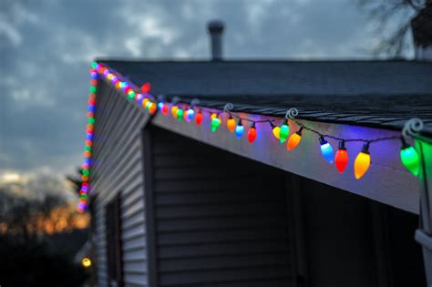 Christmas lights hanging. If you work alone, use a basket or bucket with a handle to haul your materials up and down. Put a nail or an S hook on the ladder so you can hang your tote bucket. Limit the number of times you go up and down the ladder, but do not lean to reach anything. When you can’t reach the next position, move the ladder. 