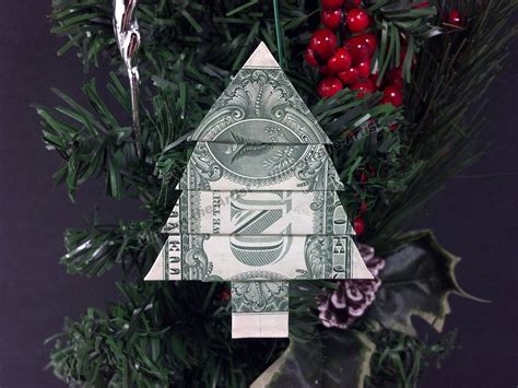 Christmas origami dollar. She has a 120-page book called Easy Origami Ornaments featuring 60 of her original designs. The few that you see below are just the tip of the iceberg! Another good book for Christmas decorations is The Magic of Origami by Alice Gray and Kunihiko Kasahara. This book is is a classic and a treasure to have! 