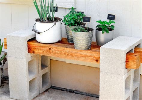 Once complete, this plant stand provides enough room on each shelf for at least six planters. And since the foundation of the shelves is concrete blocks, bearing weight is no burden! Enjoy two long shelves filled with all of your terracotta pots or use one shelf to store some of your supplies. 2. Two Drawer Repurposed Plant Stand. 