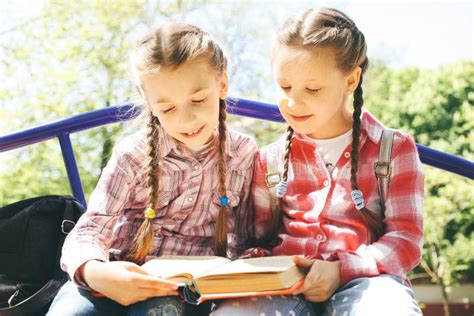 Classmates Sit and Read a Book Stock Image Image of model, human