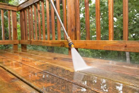 Cleaning a deck. Cleaning and restaining a deck. In the backpack pump sprayer, mix a one-to-one ratio of biodegradable wood cleaner to water. Use a garden hose to wet down the entire deck. Spray the wood cleaner solution onto the deck and railings, then wait 10 minutes. Scrub the wood surface with a stiff-bristle brush to remove loosened dirt and grime. 