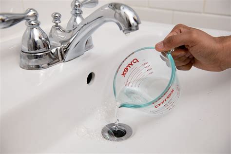 Cleaning drains with baking soda and vinegar. Mix 1/2 cup of baking soda with 1/2 cup of vinegar in a measuring cup or bowl. Pour the mixture down the clogged drain. Let it sit for about 30 minutes to allow the foaming action to break down the clog. After the time has passed, flush the drain with hot water to clear away any remaining debris. 