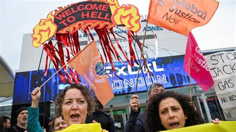 Climate change protesters carried out of Shell shareholders meeting
