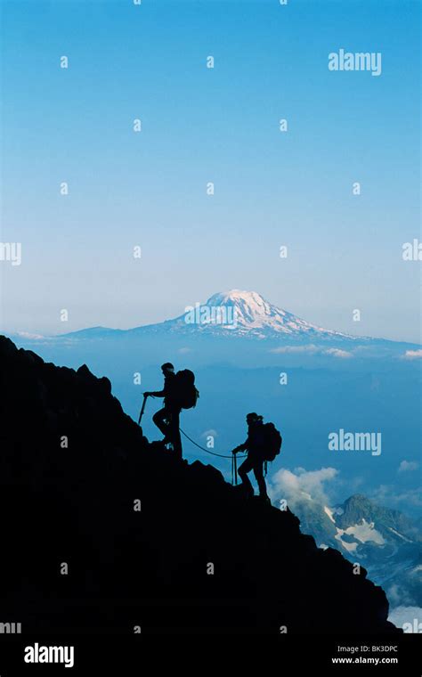 Climbing mountain is called.  Climbers ascending Mount Rainier looking at Li...