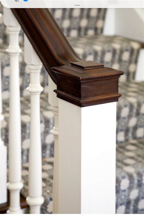 Closeup of newel post stained cap matches handrail