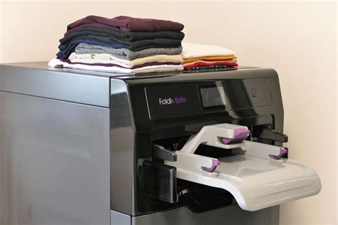 Clothes folding machine. About cloth folding machine: An automatic clothes folder is a robot that folds clothes, allowing them to be stored in an orderly and compact way. They are also called laundry-folding machines and laundry-folding robots. Laundry folding machines can be attached to or connected with washing machines, ironing machines, or clothes dryers. 