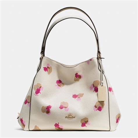 Perfect for day-to-day events -- and so much more! The Highline Tote from Coach flaunts a vintage-inspired floral print and spacious interior. Large sized bag; 14-1/4"W x 12-1/4"H x 4-1/4"D (width is measured across the bottom of handbag) Silhouette is based off 5'9" model; 9-3/4"L strap; Gold-tone or silver-tone exterior hardware, varies by color . 