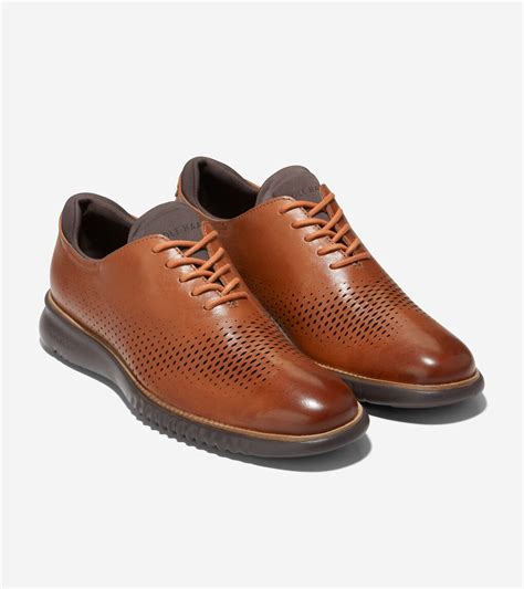 Step out in bold style with these athleisure Cole Haan® 2.Zerogrand Laser Wingtip Oxfords.Leather upper features perforated detail.Lace-up front.Embossed.... 