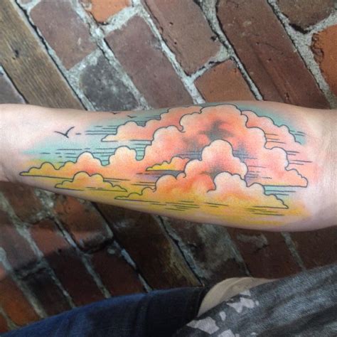 Color cloud tattoos. A cloud tattoo can be a powerful symbol of liberation and freedom. It serves as a visual representation of the concept, drawing inspiration from the way clouds effortlessly drift across the vast expanse of the sky. Cloud tattoos remind us to embrace our independence, break free from constraints, and soar towards our dreams. 