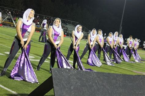 Color guard description. In a Marching Band, the color guard is a non-musical section that provides additional visual aspects to the performance. The marching band and color guard ... 