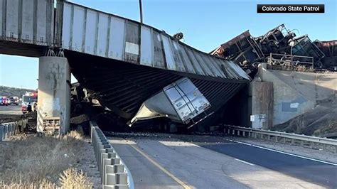 Colorado’s I-25 partially closed after coal train derails off bridge and kills a semi-truck driver, authorities say