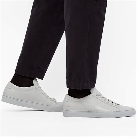 Common projects achilles. Description. Founded in pursuit of the perfect pair of trainers, Common Projects achieves its goal with this Achilles Low pair. Made from luxurious leather, they’re accented only with the label’s minimalist gold foil branding for an understated aesthetic that’s perfect for any occasion. Leather Uppers. Leather Lining. 