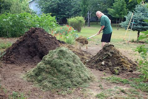 Composting grass clippings. Lay a bed of grass clippings from lawn. Helps to keep the pile warm and rotting. I will take half the dirt from a garden bed. A literal half not the top ... 
