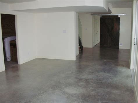 Concrete basement floor. Small cracks in a concrete floor commonly result from shrinkage as the concrete dries, which pulls the concrete apart. These cracks can show up as long as a year after the concrete basement floor is poured, depending on how quickly the slab dries and how humid the basement is. What to Do: Nothing. Hairline cracks in the basement … 