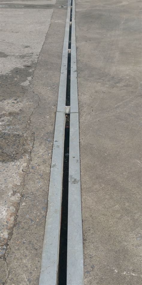 Concrete drainage channel. Great for draining landscape beds. This is a five inch wide channel drain kit, with a 40 inch long modular drain, an end cap, and an end outlet. System is designed so that it can be cut to almost any length. It is designed to handle light, low speed traffic. Unit has both side drain and bottom drain options. 