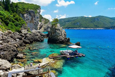 Corfu greece. Corfu is an island off the northwest coast of Greece in the Ionian Sea that is defined by rugged mountainous terrain, lots of luxurious resorts and a ... 