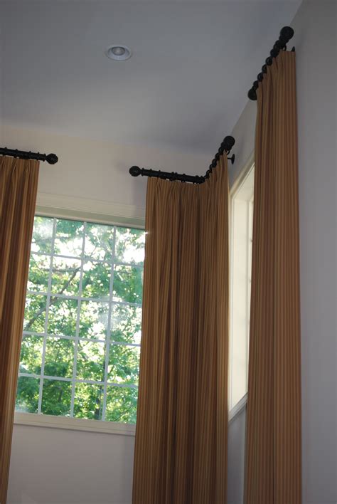 Corner curtain rods. The Loïc Corner Single Curtain Rod attaches via a corner ball connector that allows for nearly 360 degrees of rotation. These high-quality steel rods are accented with decorative finial end pieces. Material: Metal; Rod Diameter: 0.81'' These are very high quality, heavy, beautiful curtains. They look stunning in my nursery. 
