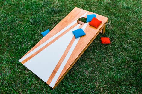 Cornhole diy. I love a good yard game. Summer time with a fruity drink in your hand and a handful of yard games is a great way to spend a summer afternoon or evening. My husband has always loved the game cornhole which is basically a bean bag toss game where you are trying to get bags into a hole on a wooden board (the bags are traditional filled with corn so hence the … 