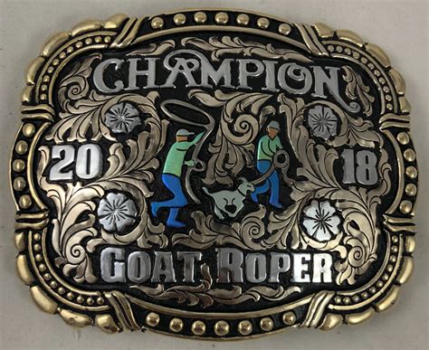 Corriente buckle. CBE 464. What a better way for someone to display an achievement than a stunning glimmer of a trophy belt buckle. Each custom trophy belt buckles is handmade with lettering to your specifications. The back has a hook for the belt hole and a swivel bar. We have any figurine you may need for the event you need; team roper, barrel racer, swine ... 