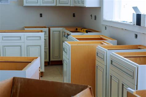 Cost to install cabinets. However, for example, a 12 feet by 12 feet kitchen will have about 25 linear feet of cabinets which can cost up to $30,000. The larger the kitchen, the more will cabinets cost. or as much as $29,000. These are average kitchen sizes, but larger kitchens will cost more. Cabinet configuration will also affect the price. 