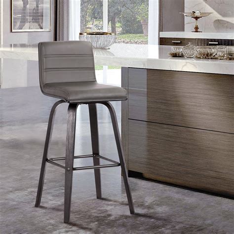 This counter stool pairs classic style and neutral tones for a modern farmhouse look we love. It has a solid and engineered wood frame with a neutral finish, and it stands on a four-legged swivel base connected by a built-in footrest bar. This stool features a barrel-style back and a round seat, and it's wrapped in polyester upholstery in a solid hue. The seat is filled with foam for extra ... . 
