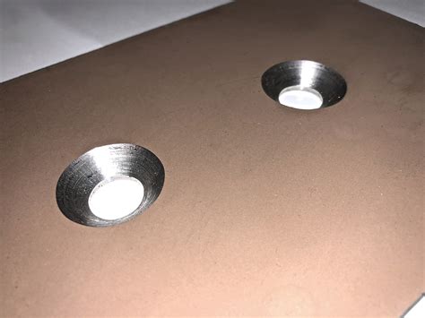 Countersunk hole. The Countersink Depth Calculator is a tool used in machining and carpentry to determine the appropriate depth for creating countersunk holes or recesses in a material. Countersinking involves creating a conical or tapered recess to allow the head of a screw or bolt to sit flush with the surface. 