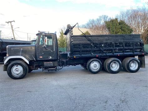 2002 Kenworth T800 quad axle dump truck Steel box with high lift gate , paving tail 8LL eaton fuller Air ride suspension Cat C12 engine less than 1k miles on fresh inframe …. 