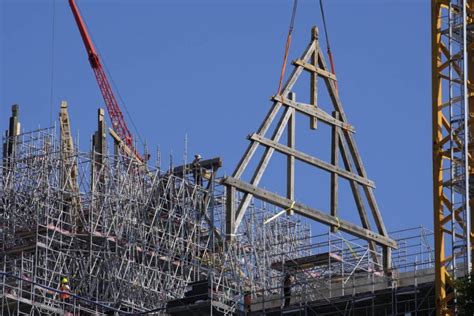 Crane at fire-ravaged Notre Dame in Paris hoists giant wood trusses to the cathedral’s roof