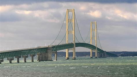 Crane hits mackinac bridge. The Mackinac Bridge, connecting Michigan's upper and lower peninsula, was recently hit by a barge carrying a boom crane.According to 9and10News, the bridge still needs to be repaired and the exact cause of the damage remains under investigation.Mackinac Bridge Authority spokesperson James Lake described the … 