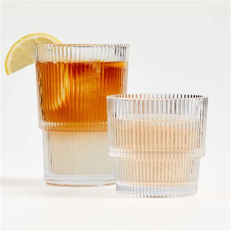 Sparkling tiers of ribbed glass shape a highball glass that’s equally suited to casual sips of lemonade and formal toasts. The countless glass ridges provide a sturdy handhold while catching the light. Add the Atwell double old-fashioned glass and decanter for a coordinated cocktail hour and bar cart. Dishwasher-safe for easy cleanup. . 