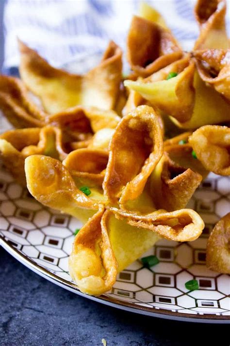Cream cheese wontons near me. Place the cream cheese wonton in the air fryer coating both sides well with olive oil spray. Start by cooking them with the points facing down. Bake them at 350˚F for 4 minutes. Spray the cream cheese puffs with olive oil, flip them over and spray the top side. Then, cook at 350˚F for 4-6 minutes, until golden brown. 