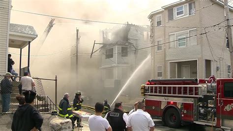 Crews battle fire at Lawrence triple-decker where front of building collapsed