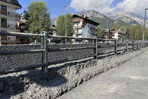 Crews clear roads after mudslide in the Italian Alps coats city streets in muck