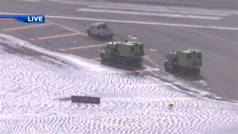 Crews work to clear standing water on runway at FLL
