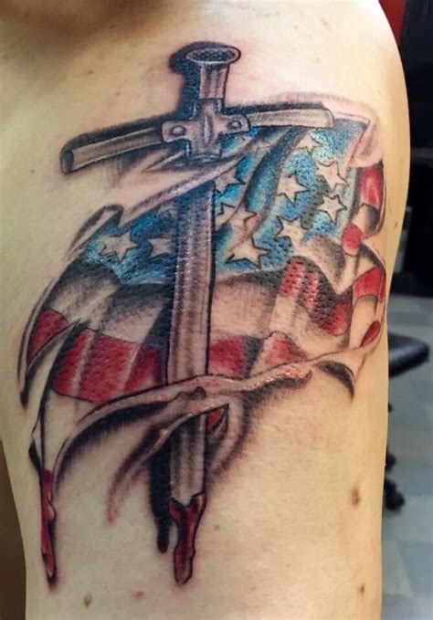 Cross american flag tattoo black and white. The Black Flag tattoo is like a proud symbol of bravery and independence. It gives off an air of daring stories and unbreakable spirits. Behind its bold exterior is a treasure trove of symbols that go beyond the everyday. From the fierce rebellion of the pirate to the bold spirit of the modern rebel, this symbol represents freedom, independence ... 