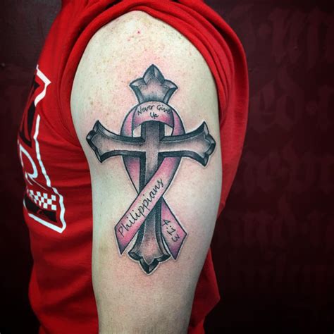 Cross and breast cancer ribbon tattoo. The most common cancer ribbon colors are pink for breast cancer, gray for brain cancer and lavender for general cancer. Other ribbon colors include dark blue for colon cancer, oran... 