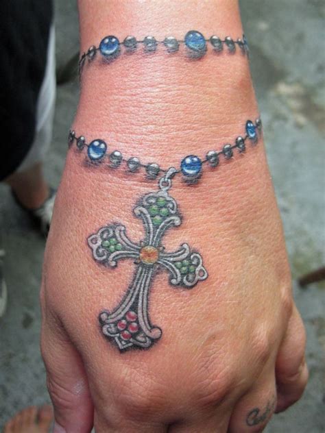 Cross rosary tattoo designs. Tattoo artists are known for their ability to create stunning, intricate designs on the human canvas. One of the most crucial skills in this craft is mastering color theory. To mas... 