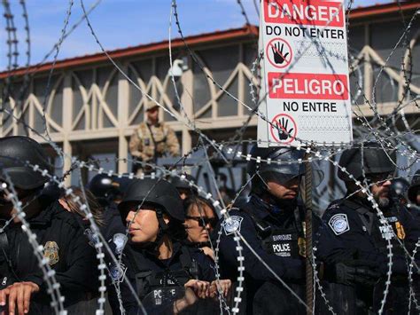 Crowd at U.S.-Mexico border stopped by barricades at bridge
