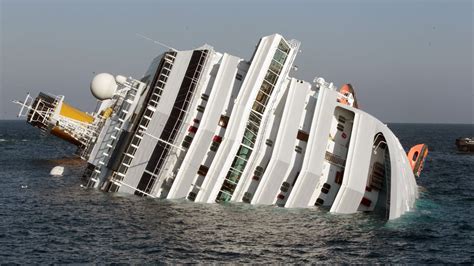 Technicians pass in a small boat near the stricken cruise liner Costa Concordia lying aground in front of the Isola del Giglio on January 26, 2012 after hitting …Web. 