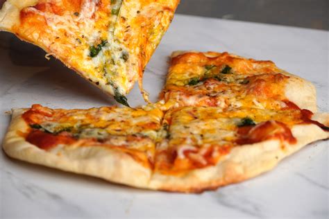 Crunchy thin crust. A Brooklyn-style pizza is characterized by a thin crust that is crunchy on the outside and soft on the inside, with tomato sauce and mozzarella cheese made from half skim and half ... 