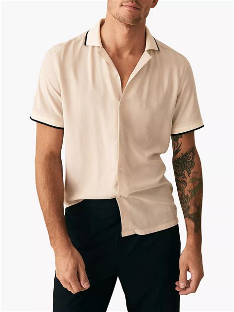 Cuban collar shirt. A Cuban collar and embroidered detailing refine the look. Fasten the shirt or wear undone for a laidback mood, and pair with tonal shorts and trainers. Cuban collar Button front closure Short sleeves Embroidered detailing. Date. Price. January 2024. $225. January 2024. $225. 