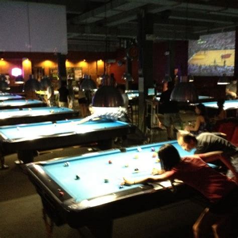 Cue bar. Cue Bar is a one-of-a-kind Billiards Hall offering fun for the entire family. It has 21 pool tables, 2 ping pong tables, a full bar, restaurant and lounge, and 2 big screens for sports. … 