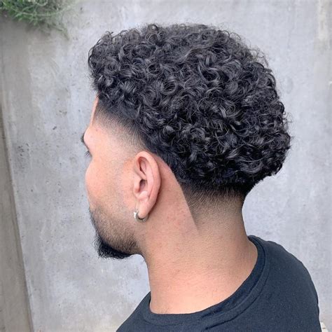 Curly hair with low taper. Here are some of the best tape fade cuts for people with curly hair: 1. Low Taper Fade With Tight Curls. Guys with tight curls can try the low taper fade for a cool and easy-to-maintain hairstyle. There will be a great volume of tight curls on the top, while the sides will have a low fade around the ear, offering a cool contrast. ... 