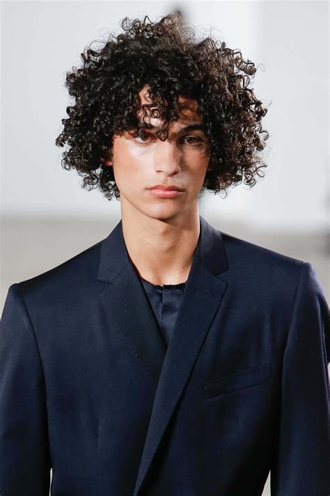 Curly men. 14. Curly and Wavy Layers Give your long straight hair some flavor with the help of a styling tool. Bump the ends with a flat iron. Get a natural-looking curly or wavy hairstyle by raking Axe Natural Look: Softening Cream through your wet hair. With this hairstyle, layers make the look. 