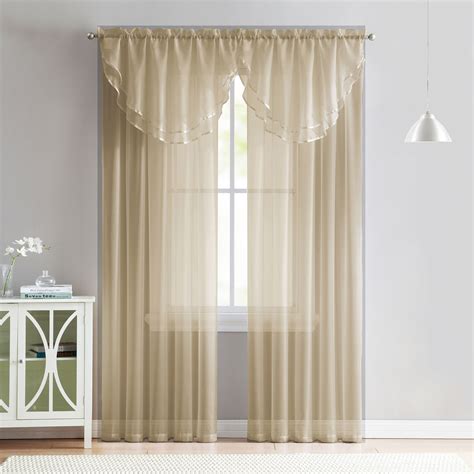 A stylish addition to your bedroom, living room, or more, this curtain panel features an embroidered scroll panel with a solid ivory backing and an attached valance to create a layered look. Each panel measures 40 x 84 inches with an 18-inch valance and has a rod pocket top for each hanging and styling.. Curtain valances for living room