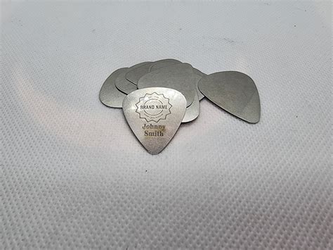 Custom metal guitar picks.  World wide shipping hand made work of arts.  Chec...