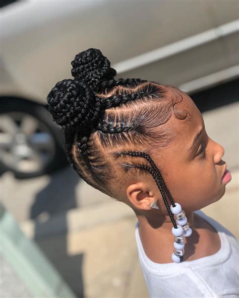 6) Three Cornrows Ponytails with Curled Ends. These ponytail cornrows are perfect for grade school kids. To prevent discomfort and protect her edges, you can leave out her baby hairs instead of forcefully pulling on them. If her hair is long enough, you can skip using hair extensions and just twist the ends.. 