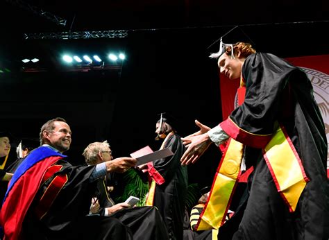 DU graduates each receive surprise $500 gift from homebuilder Pat Hamill at commencement